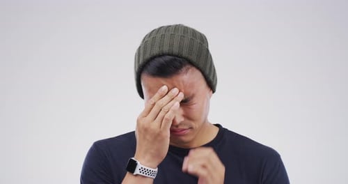 Man Rubs Temples Indicating Headache Pain