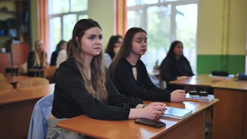 High School Students Actively Engaged in a Classroom Lesson Listening Attentively to Their Teacher