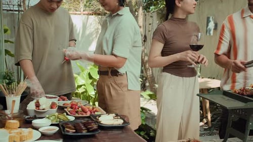 Friends Enjoying an Outdoor Barbecue on a Sunny Day
