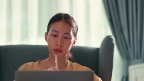 Woman Uses Laptop in Bright Home Setting
