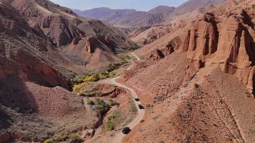 Offroad Cars on Winding Road Konorchek Canyons Kyrgyzstan Aerial View