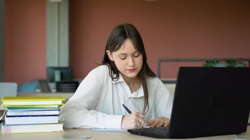 Woman Student Studying at Desk with Laptop