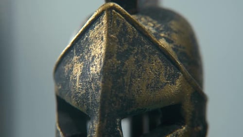 A close-up detailed shot of a Spartan design, two different ancient warrior metal bronze top of the