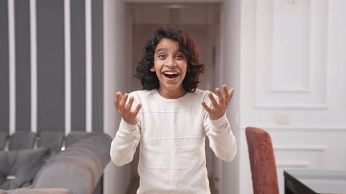 Excited Teen Smiles With Joy Indoors