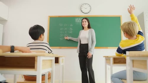 Group of student learn with teacher in classroom at elementary school.