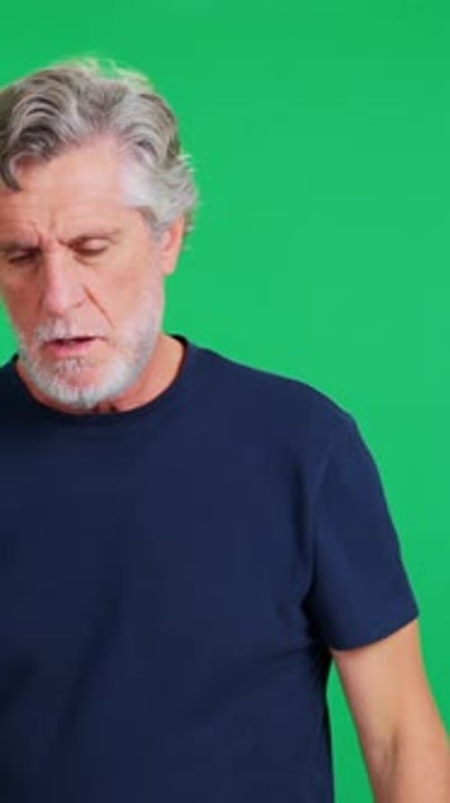 Mature Man with a Beard Coughing on Green Screen Background