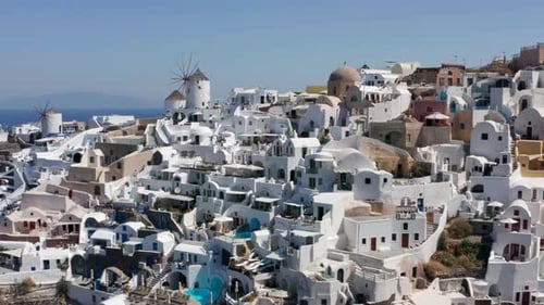 Beautiful Townscape Of Whitewashed House Structure At Oia Village, Santorini, Greece. aerial