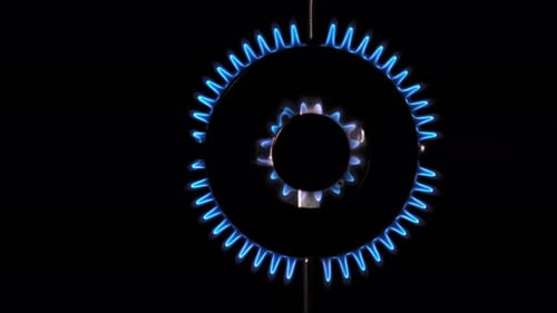 Gas Burns Blue Heat and Mirage Above the Gas Hob Switched on Top View of a Kitchen Burner Glowing at