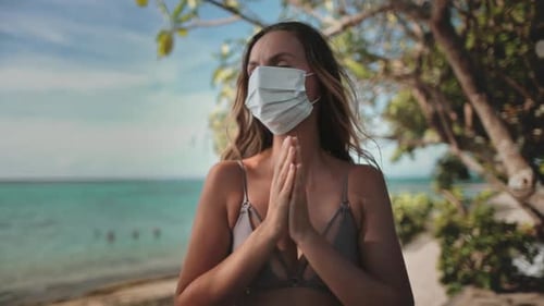 Serenity in Safety Woman Embracing the Waves in a Face Mask on the Beach