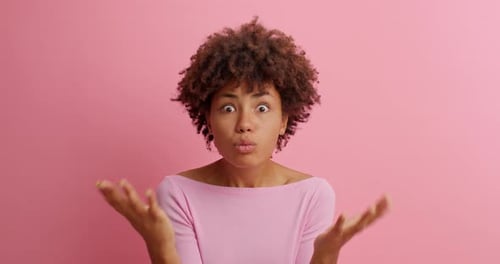 Woman with Curly Hair Expressing Confusion, Disagreement