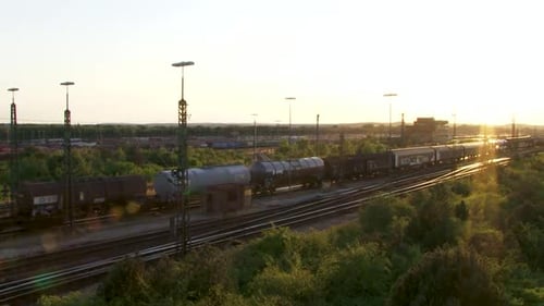 Aerial view of cargo train moving during golden hour