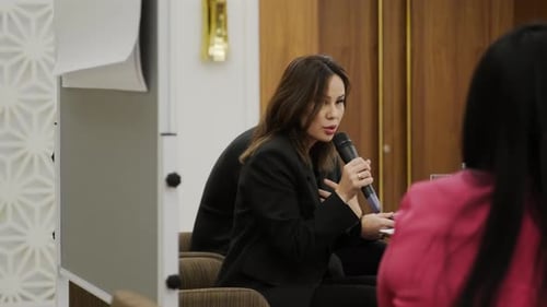 Businesswoman Giving Presentation at Conference