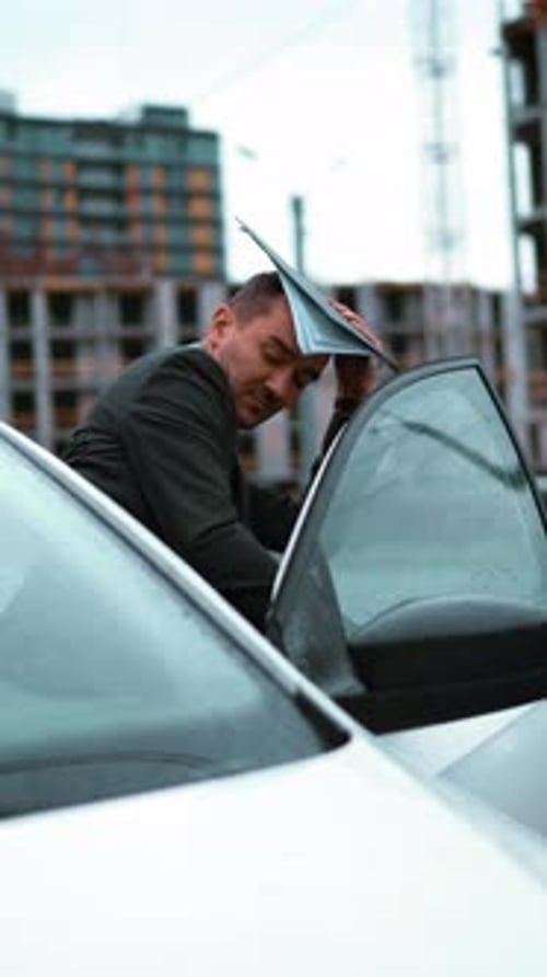 Vertical of Architect Exit His Car and Go to Building Construction