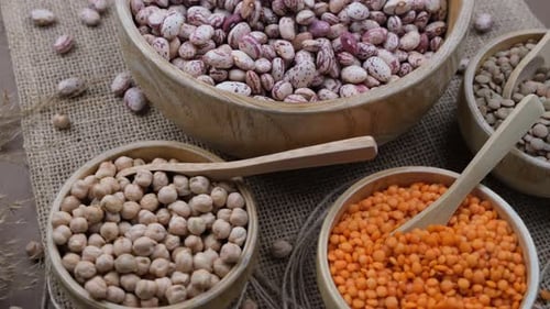 Dried Legumes in Wooden Bowls with Spoons
