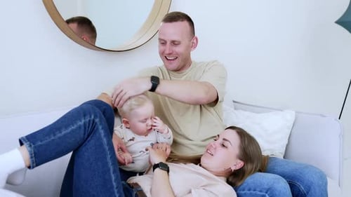 Happy Family Enjoying Time Together on Couch