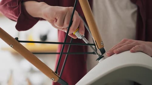 Assembling Wooden Chair Legs with Screwdriver at Home