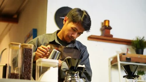 Skilled barista meticulously preparing pour-over coffee with precision and care crafting perfect cup