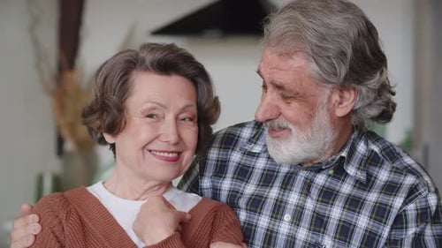 Happy Senior Couple Embracing Indoors at Home