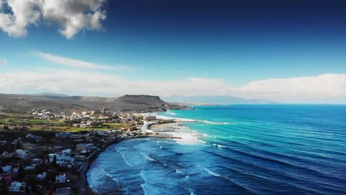Scenic view of coastal town and mountain