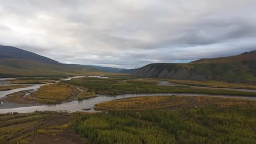 Aerial View of River Winding Through Green Landscape