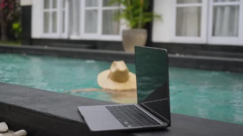 Young Freelancer Relaxing at Swimming Pool at Daytime