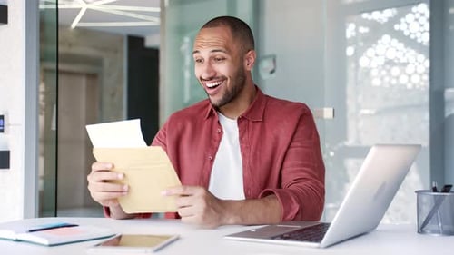 Excited Man Receives Good News via Mail in Office