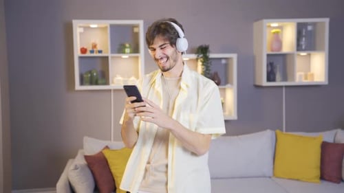 Young Adult Dancing to Music at Home
