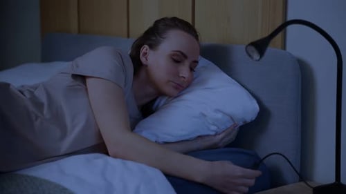 Night Shot of a Young Woman in Her Bed