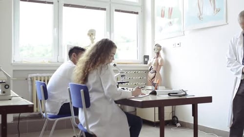 Teacher Teaching Biology to High School Students in Laboratory