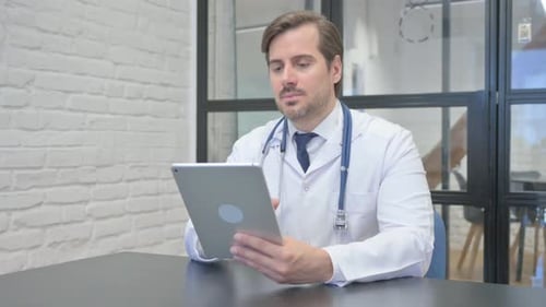Young Doctor Using Digital Tablet in Hospital