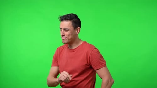 Young Adult Winking on Green Background