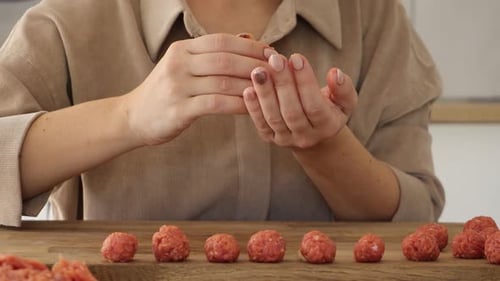 Woman Making Meatballs in a Bright Kitchen