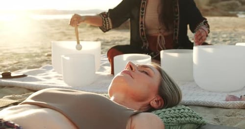 People, beach or sound therapy as healing, meditation or spiritual peace of tibetan bowls in nature