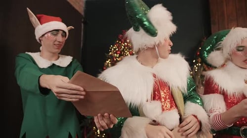 Christmas Elves Reading Letters Indoors