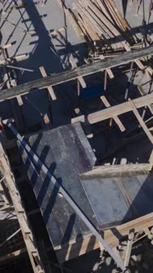 Vertical Video of Residential Construction in Progress With Workers Pouring Concrete and Installing