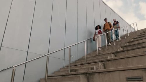 Students walking around the city, going down the stairs