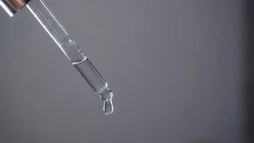 Clear Liquid Drops from Glass Pipette Close Up