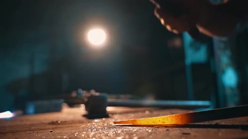 Blacksmith Shaping Hot Metal with Hammer