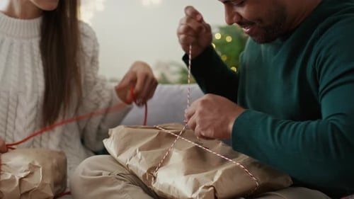 Couple Opening Christmas Gifts at Home
