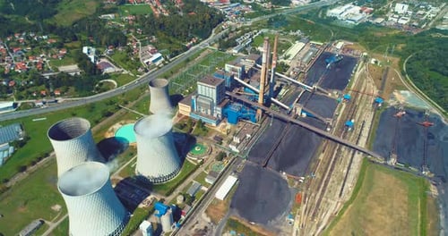 Aerial View of Coal Power Plant High Pipes with Black Smoke Moving Up Polluting Atmosphere at Sunny