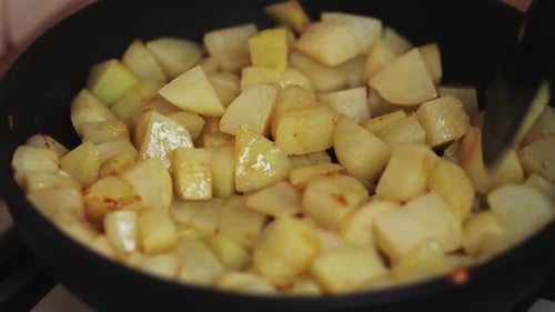 Diced Potatoes Cooking in a Frying Pan
