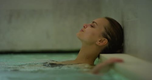 Close up of an young female is enjoying and having relax in a whirlpool bath tube in a luxury well