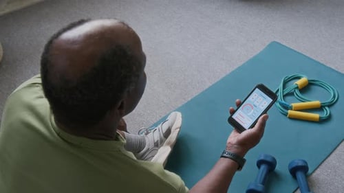Man Checks Fitness App After Workout