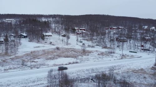 Car Driving Through Snowy Rural Winter Landscape