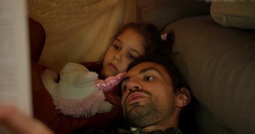 Closeup Shot of a Brunette Man in a Green Checkered Shirt Reading a Fairy Tale to His Daughter