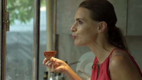 Woman Tastes Food While Cooking Indoors
