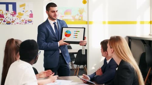 Business Presentation With Tablet Showing Charts in Office