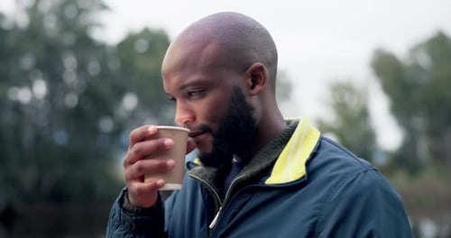 Man Sipping Beverage Outdoors
