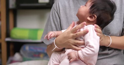 Infant Held by Adult Indoors