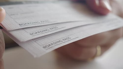 Close Up of hands Holding Three Boarding Passes